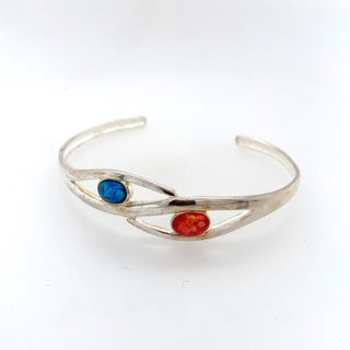 "Silver Bangle with blue and fire opal stone" available at Artifex 