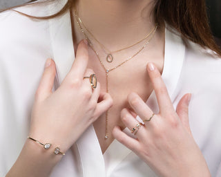 Ladies hands and neck with jewellery on